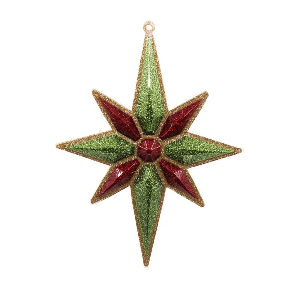 Studio shot of glitter Christmas star ornament, champagne with light green and red