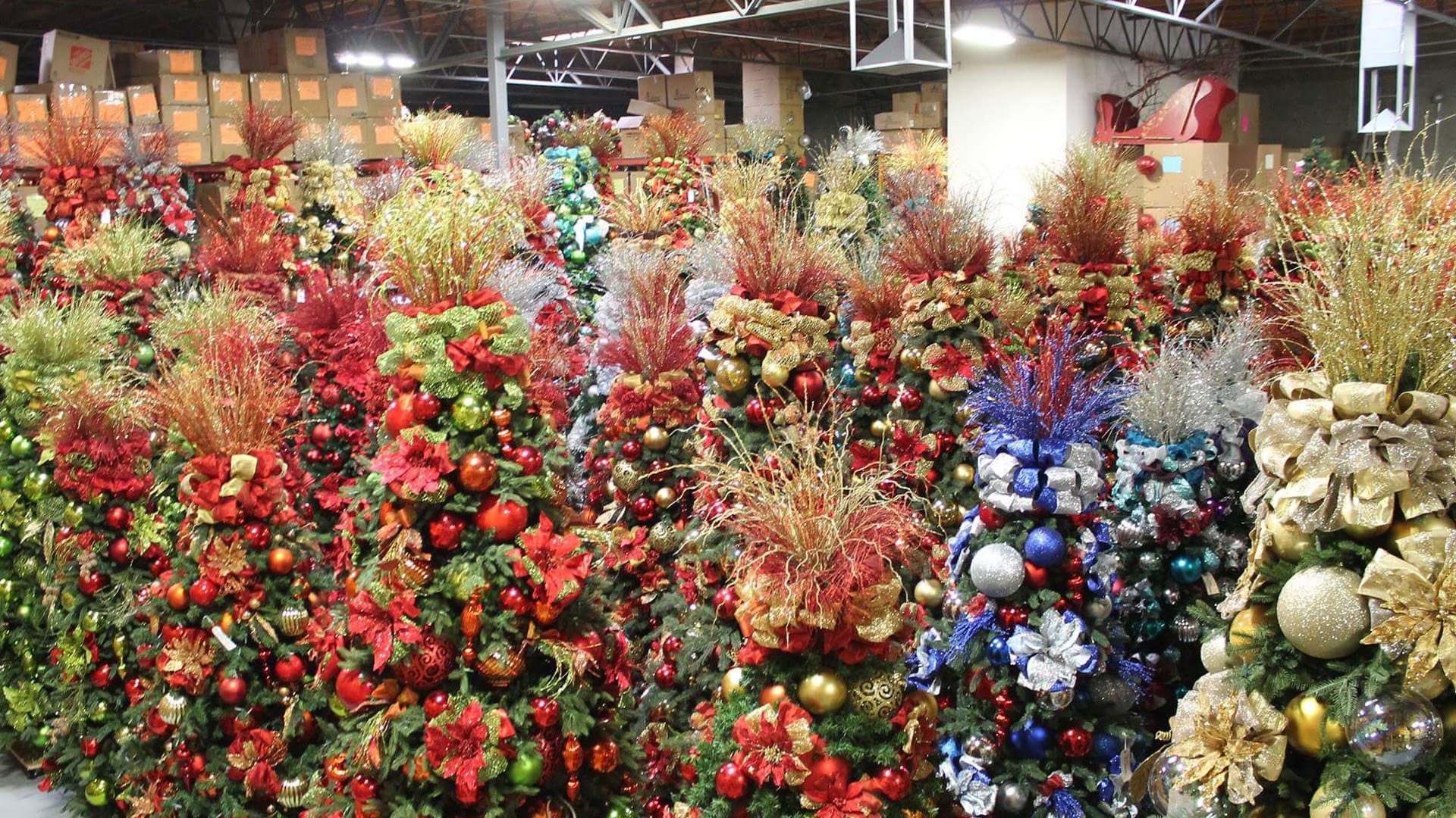 soft focus shot of decorated Christmas trees lined up in a hotel ballroom