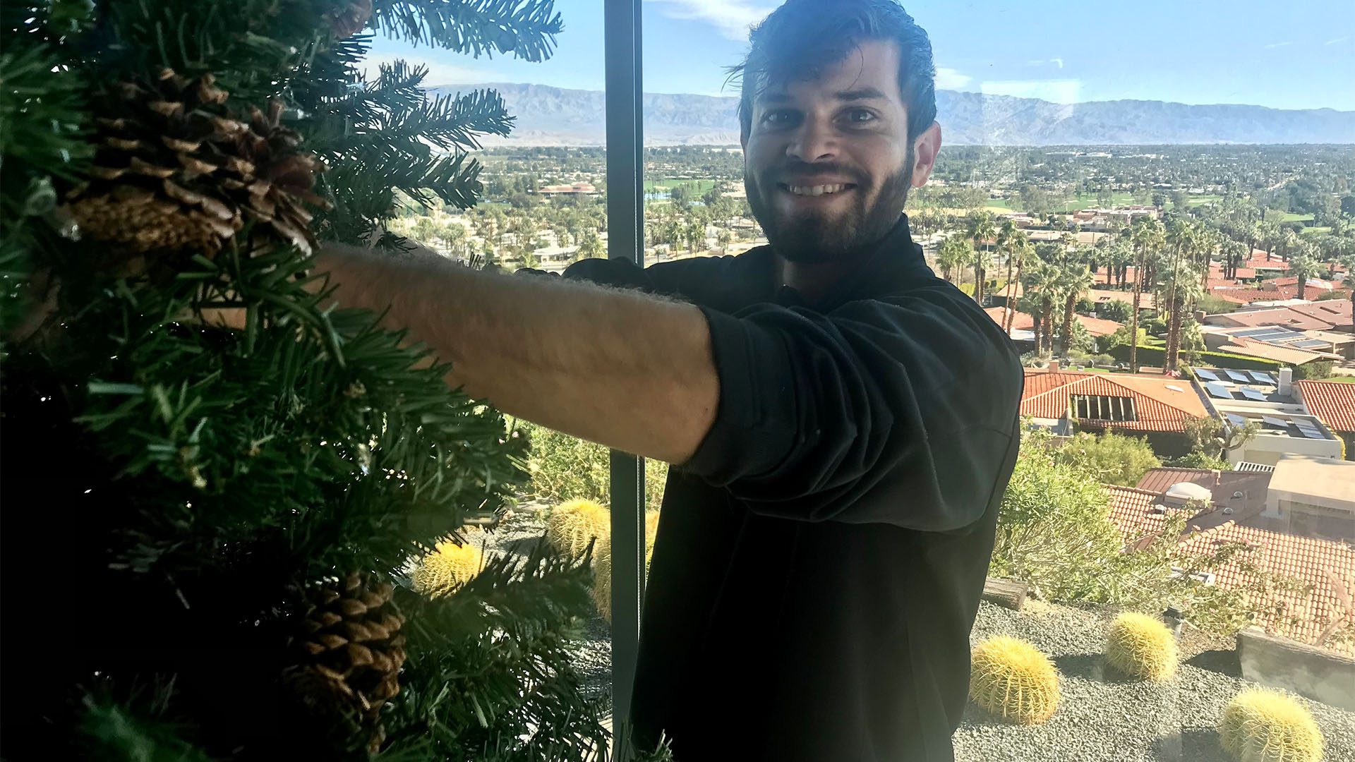 Ben Torres, Owner, on site, setting up a Christmas Tree