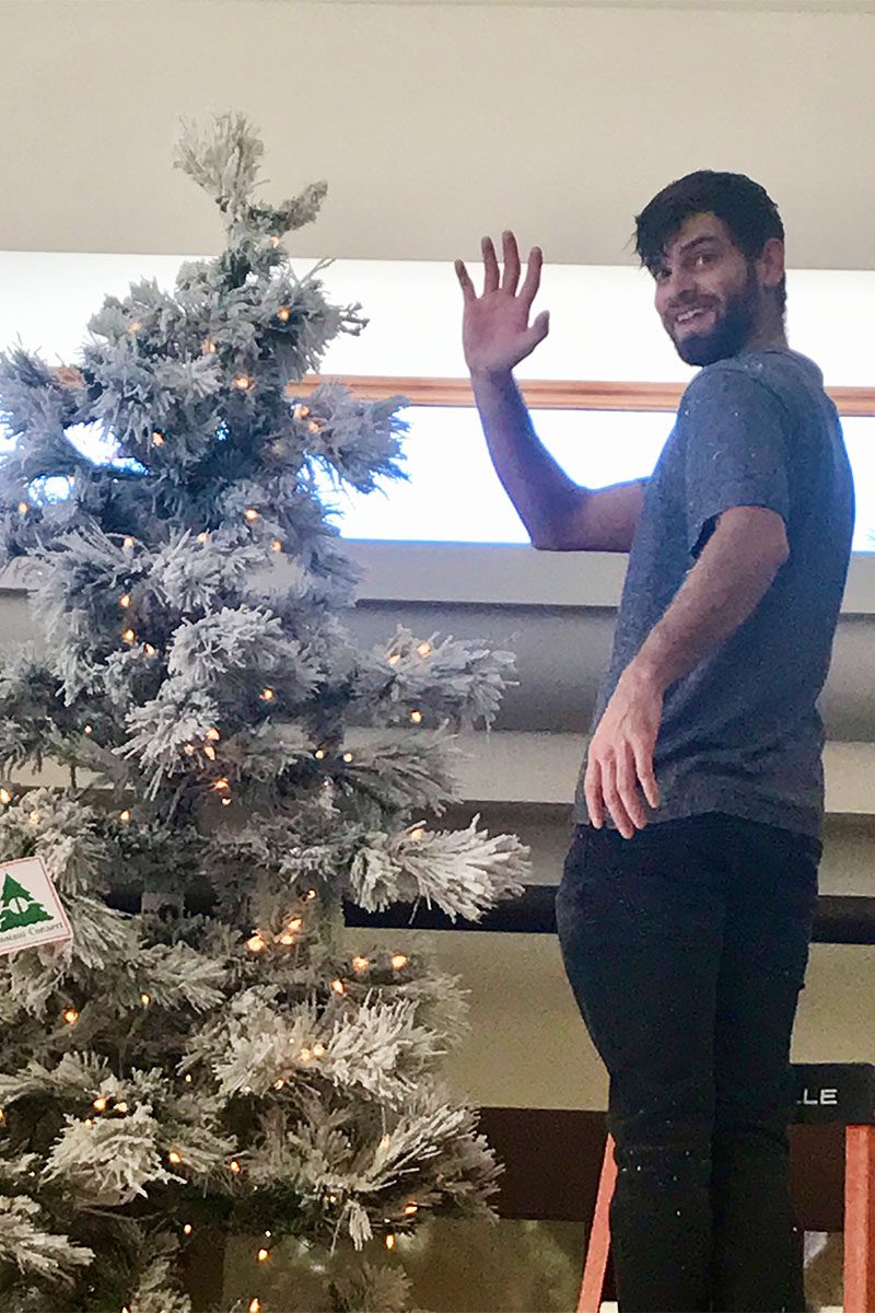 benjamin torres owner of Very Christmas Inc. Ben torres Owner, decorating a Christmas Tree